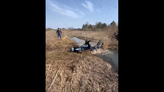 Motorcycle sinks in muddy stream after rider falls in Uren, Russia