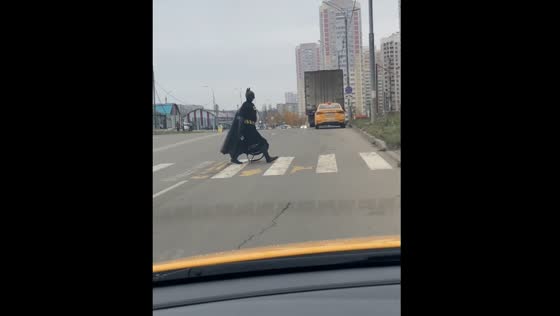 Person in Batman costume crosses road in Leninsky Urban District, Moscow Region