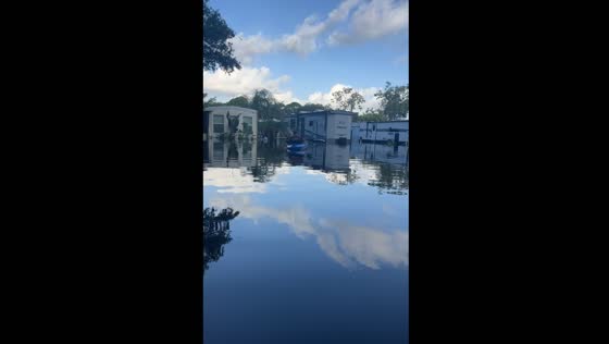 Boating through flooded streets in Dunedin, Florida