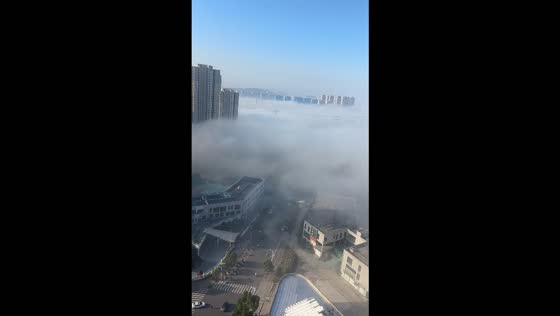 Thick sea of fog blankets an urban landscape in Jiangsu, China