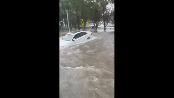 Large flood wave pushes parked car as severe flooding hits Shanghai, China