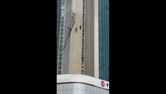 Workers hang from ropes after scaffolding failure in Henan, China