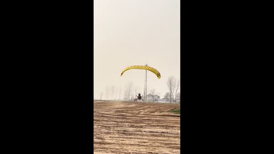Powered parachute takes off with two riders in Henan, China