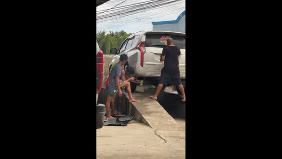 Stuffed toy being washed alongside a car in Roxas, Philippines