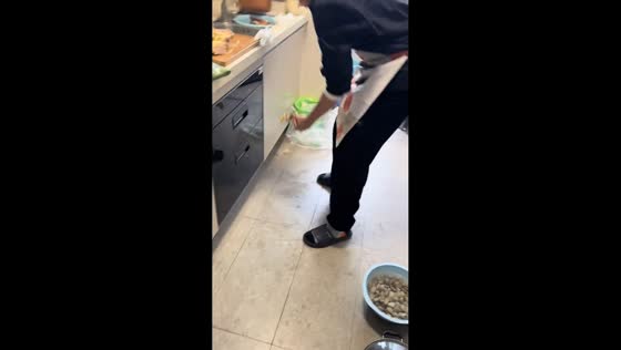 Knife snaps and bounces across kitchen while man chops chicken in Guangdong, China