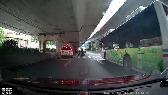 White SUV nearly collides with electric scooter rider at a pedestrian crossing in Wuhan, China