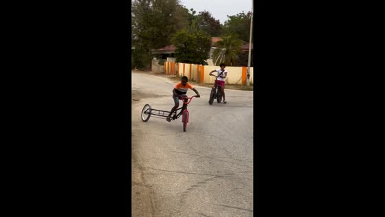 Boy drifts on custom long-frame bicycle in Kralendijk, Bonaire