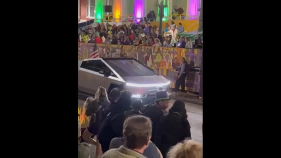 People boo a Cybertruck with an American flag during Mardi Gras parade in New Orleans