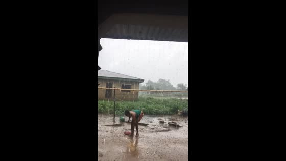 Woman slips on wet ground during heavy rain in Aramoko-Ekiti, Nigeria