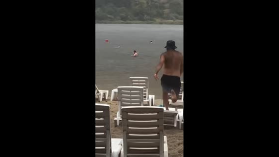Man slips while jumping onto beach lounger in Naples, Italy