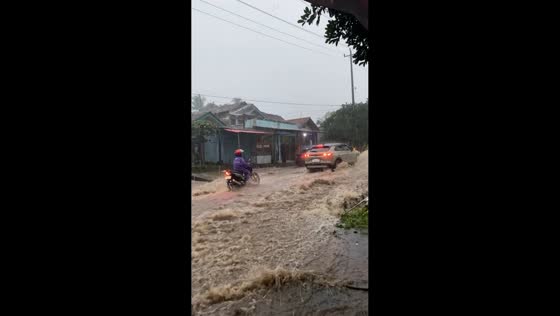 Fast-moving floodwaters sweep across Bojong–Guci highway in Tegal, Indonesia