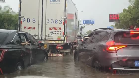 Vehicles stop in traffic as floodwater covers road in Shanghai, China