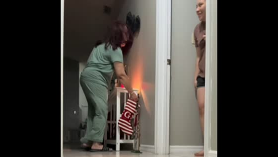 Daughter startles her mother in hallway prank in Kissimmee, Florida, USA