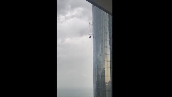 Terrifying storm swings construction worker into skyscraper
