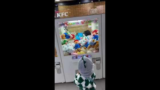 Kid scores double win on a claw machine in Suwon, South Korea