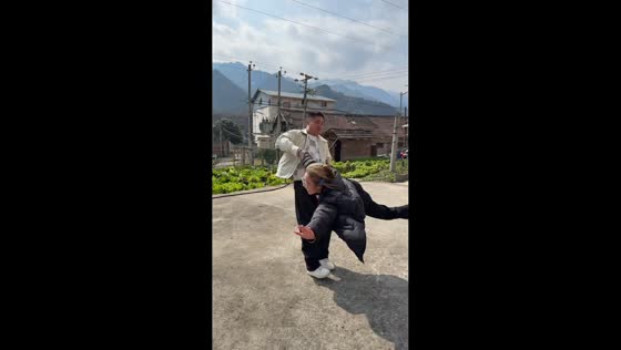 Man spins woman around by arm and leg in Shanxi, China