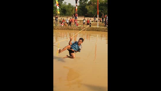 Participant falls into water during tightrope walking race in West Java, Indonesia