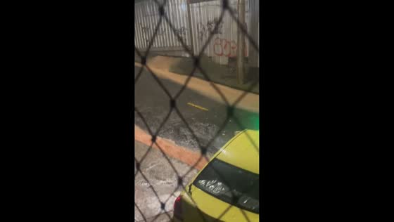 Intense rainfall sends water flowing through streets in Juiz de Fora, Minas Gerais, Brazil