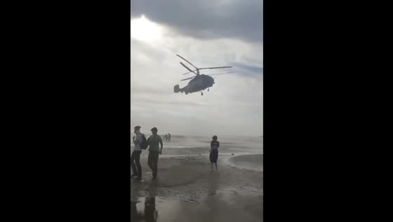Helicopter disperses swimmers from Gulf of Finland beach in Sosnovy Bor