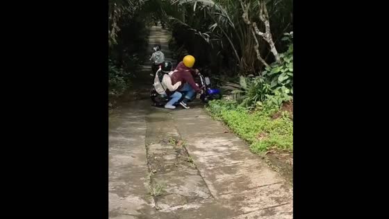 Motorbike suddenly slips and falls on road in Java, Indonesia