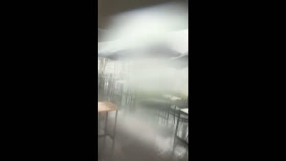 Powerful tornado sweeps tables, chairs, and umbrellas across a restaurant in Ulladulla, Australia