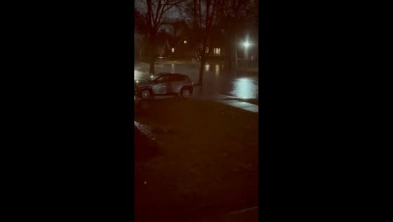 Heavy nighttime rain floods street in Chicago, Illinois, USA