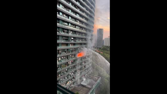Firefighters battle high-rise residential building fire in Hangzhou, Zhejiang, China
