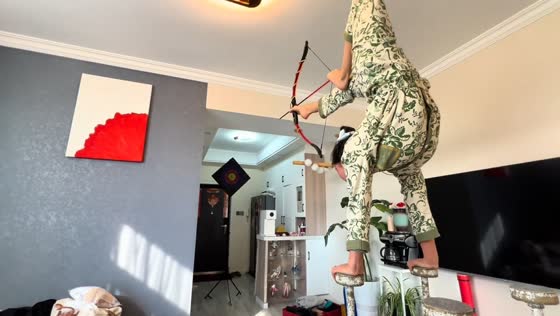 Woman performs archery with feet while handstanding in Shanghai, China