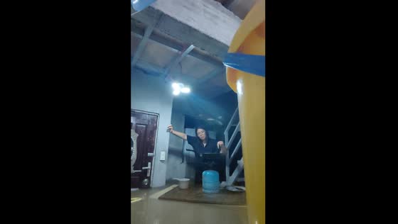 Cooking in waist-high flood waters during typhoon Gaemi in Marilao, Philippines