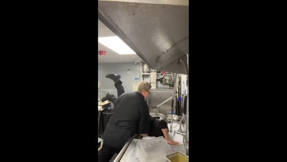Coworker playfully dunked in bubbly sink at workplace in San Francisco, California