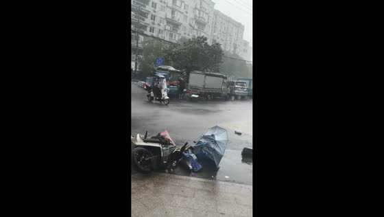 Typhoon Bavi topples parked scooters on street in Zhejiang, China
