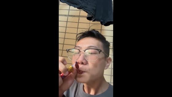 Man attempts to smoke a chili pepper and starts coughing in Guangdong, China