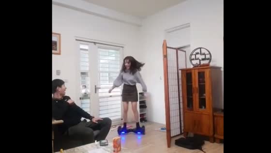 Woman struggles to balance on hoverboard in Taiwan