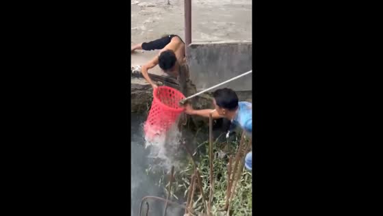 Joyful impromptu fishing adventure with a plastic bucket in Samarinda, Indonesia
