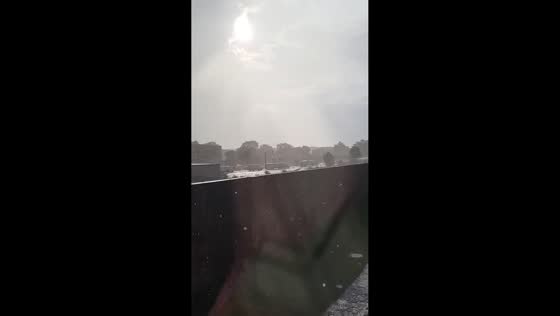 Gentle sun shower under partly sunny skies in South Boston, USA