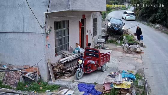 Car swerves and hits parked tricycle on small road in Hubei, China