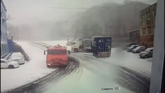 Close call on icy roads as truck slides into parked cars in Kamchatka, Russia