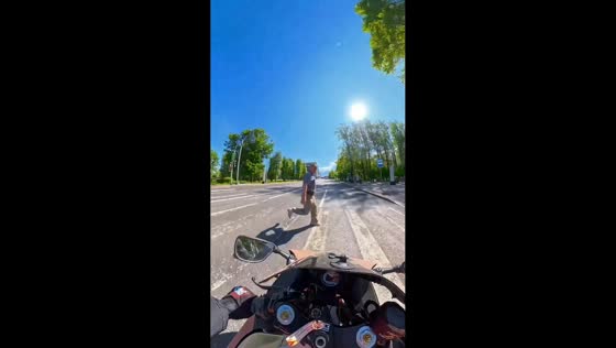 Moped rider collides with pedestrian running across the road in Moscow, Russia
