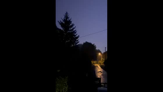 Lightning flashes over rural lane during storm in Mussidan, France