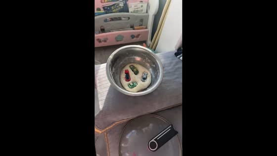 Playful child hides toys inside dough in Heilongjiang, China