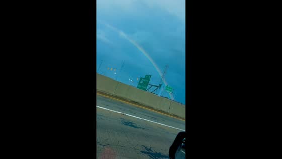 Full-size rainbow spotted near highway exit in Clarksville, Indiana