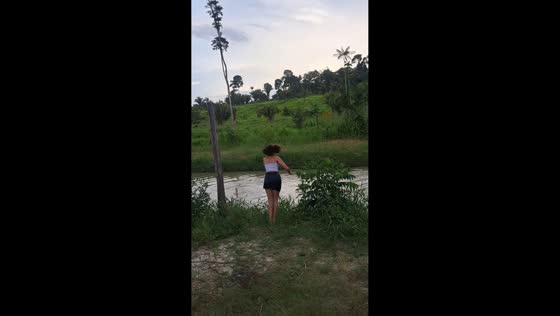 Girl misjudges lakeside edge and slips into water in Anapu, Pará, Brazil