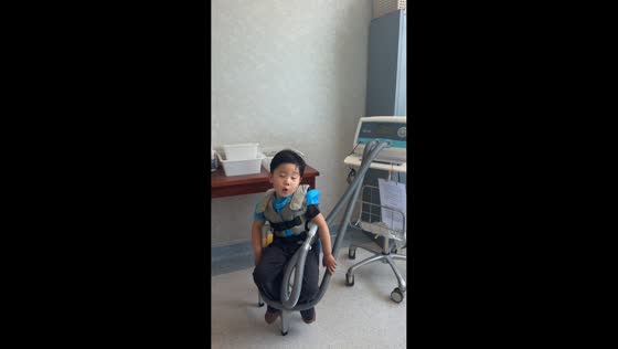 Boy makes funny sounds during chest wall oscillation therapy in Shandong, China