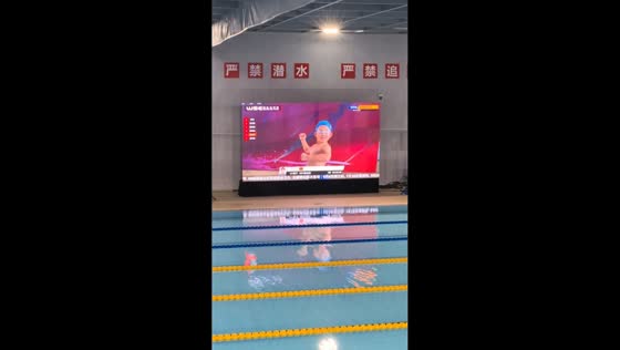 Young swimmer poses confidently during competition introductions in Guangdong, China