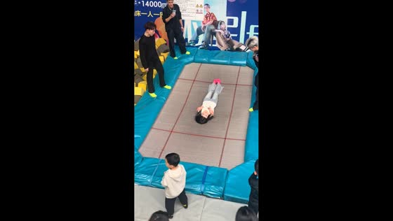 Woman lifted on trampoline in playful moment in Jilin, China