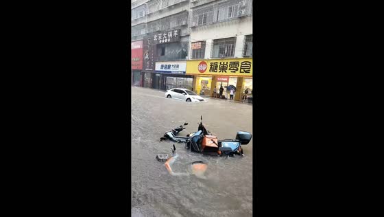 Deep floodwater engulfs vehicles along Dongjing Street in Putian, Fujian, China