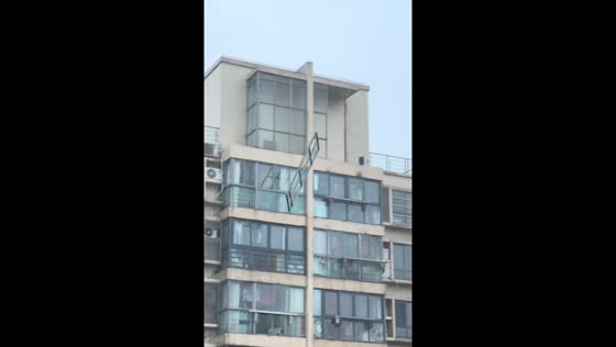 Glass panel and metal grill fall from building amid strong winds in Shanghai