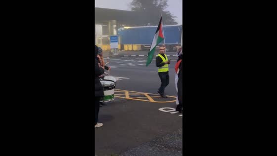 Demonstrators wave Palestinian flags during protest at Tilbury Port in England, UK