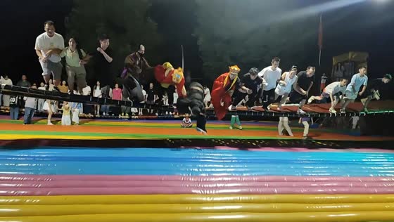 Pigsy character loses balance and falls during swaying bridge game in Hubei, China