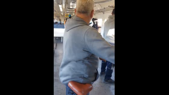 Rush hour chaos: commuters boarding through train windows for seats